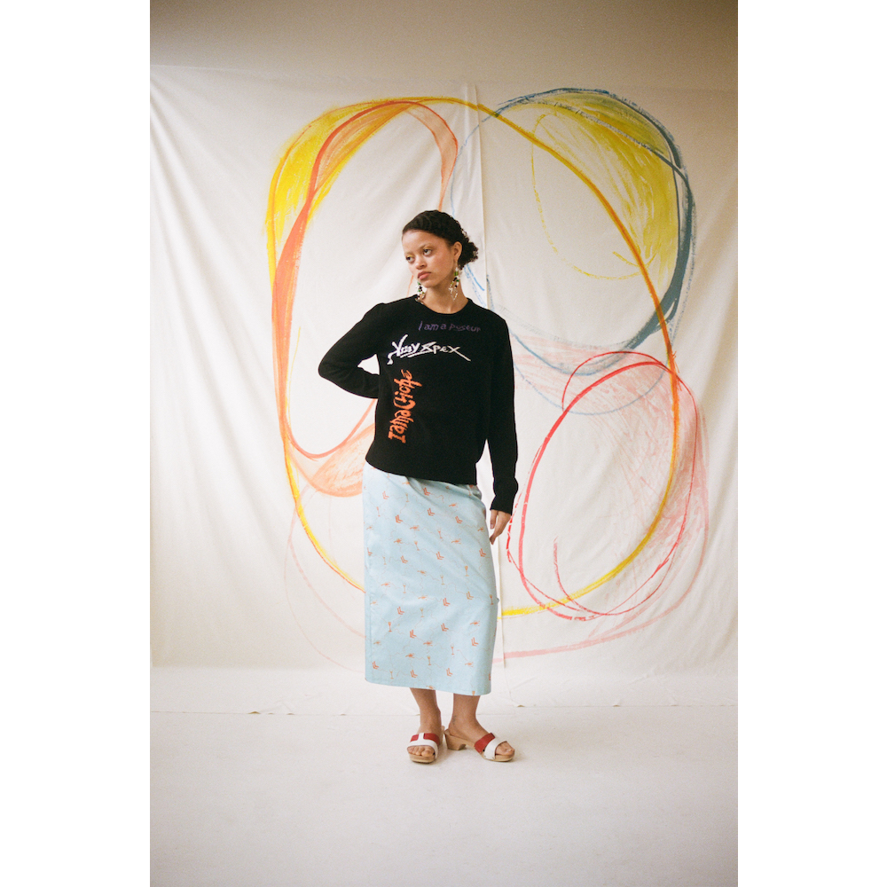 Model wearing the 'I am a Cliché' jumper styled with the Dorothea skirt