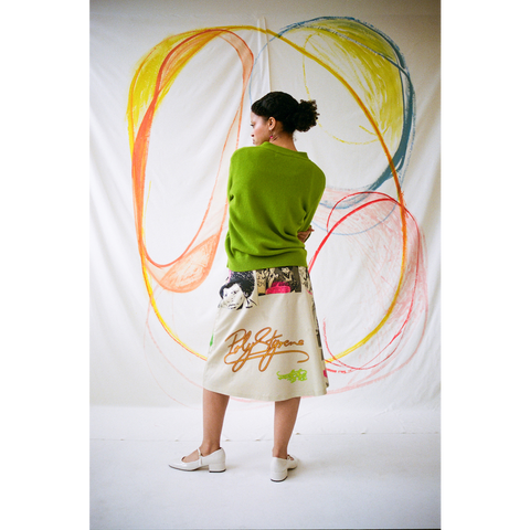 Model wearing the 'I Am A Poseur' skirt styles with the HADES Lime Logo cardigan.