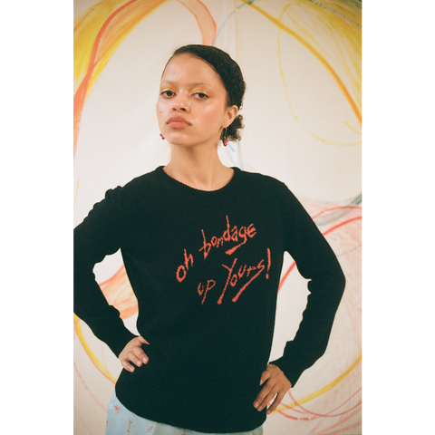 Model wearing the 'Oh Bondage, Up Yours!' jumper in Black and orange