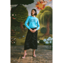 Model wearing a "Make Friends With Chaos" knit and a "Notes on Radical Living" skirt against a faux garden of eden backdrop.