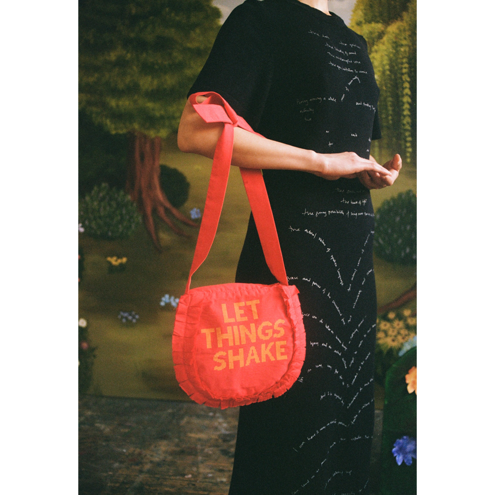 Model carrying the "Let Things Shake" bag.