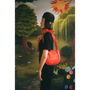 Model carrying the "Let Things Shake" bag in front of  a faux garden of eden.