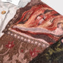 Upclose image of the detail on the William Blake cardigan. 